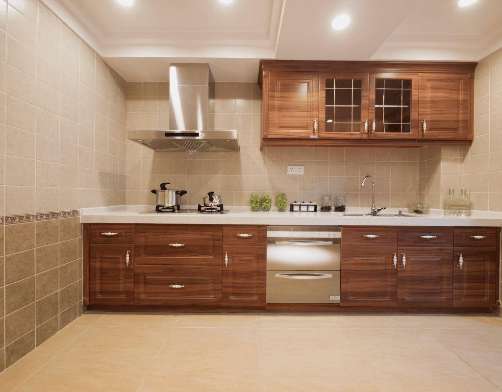 Kitchen with dark wood cabinets, a stainless range hood, tiled backsplash and beige tile flooring